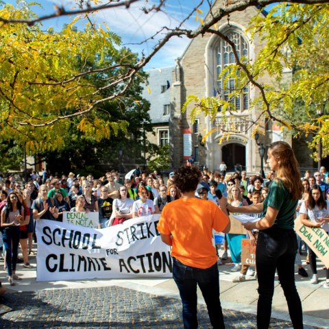 Students gathered on Ho Plaza holding signs about climate change.