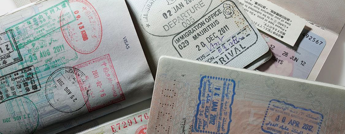 Open passports with stamps from different countries. 