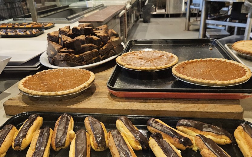 Pies and eclairs on a counter. 