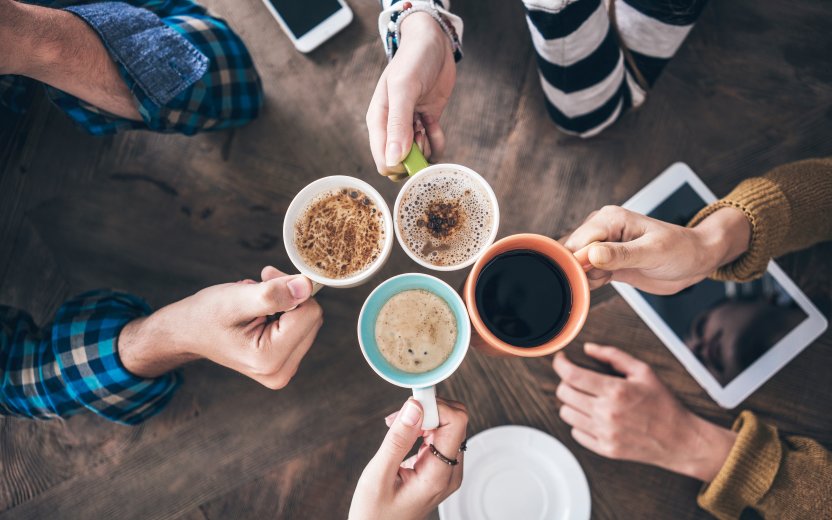 Looking into four cups of coffee from above.