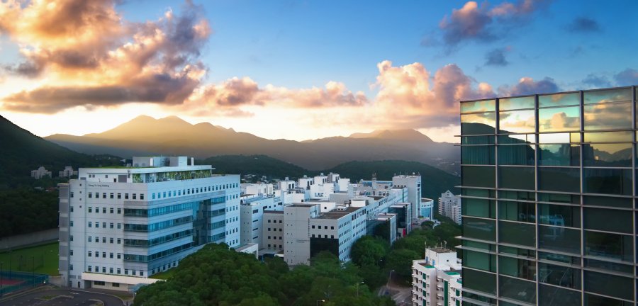 Skyline view of HKUST campus with glass building in the foreground.