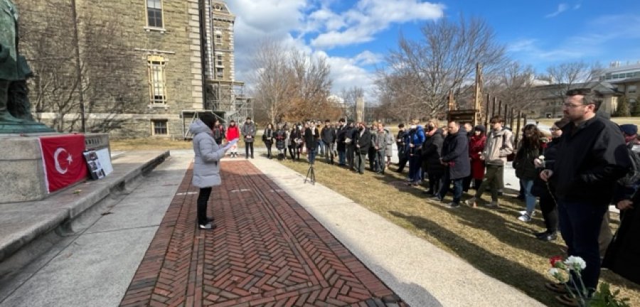 Esra Akcan addressing a crowd in front of Ezra Cornell's statue on the Arts Quad.