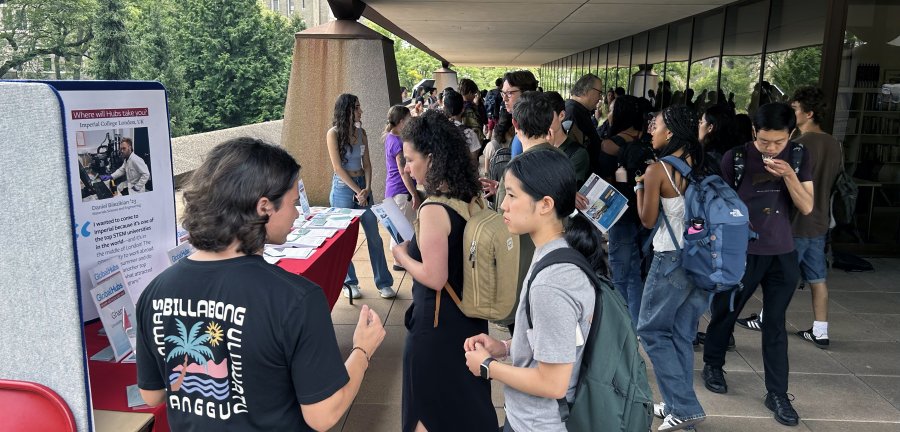 Students walking through the fair under Uris Terrace.