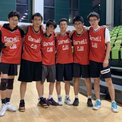 Six student standing arm-in-arm in a gym, wearing basketball uniforms that say Cornell ZJU.