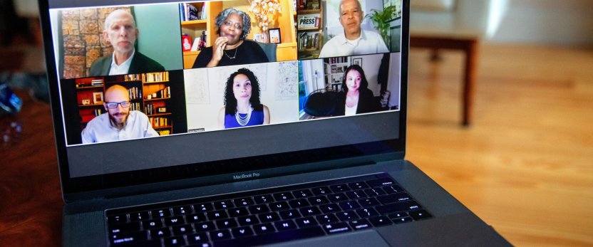 Six people on a Zoom screen on a laptop.
