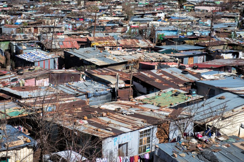 Closely placed rusty metal homes in Soweto town
