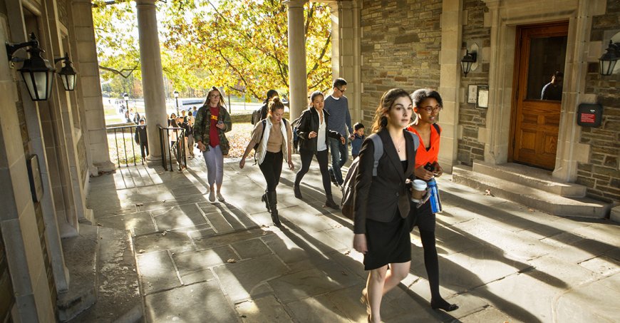Students walk through the Balch Hall archway in fall
