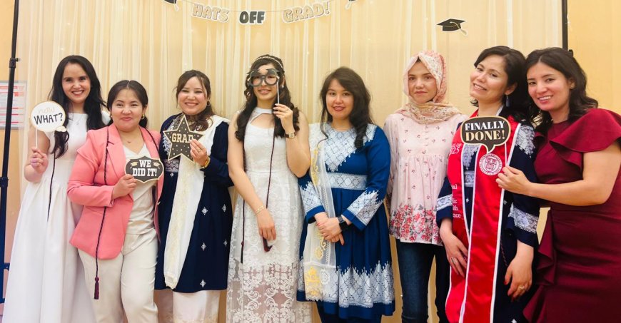 Eight students gathered with celebratory graduation signs