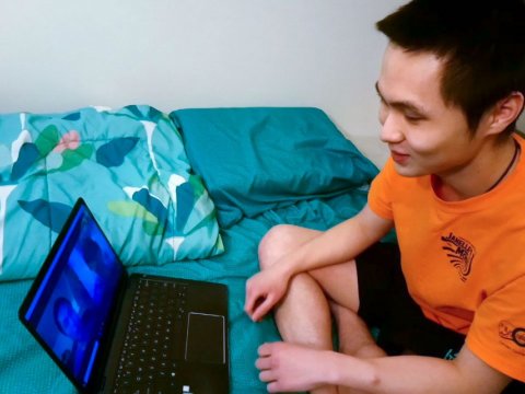 Yao Yu Yeo video conferences with his brother and sister