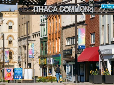 Downtown pedestrian shopping area with a sign that reads Ithaca Commons