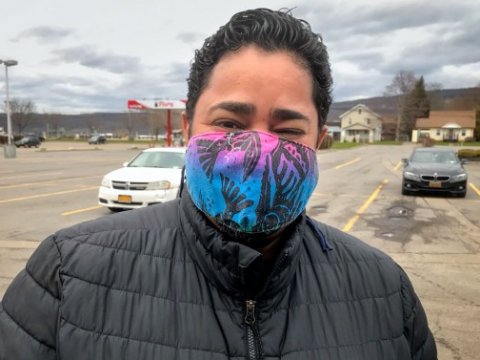 Woman outside wearing a colorful facemark. Provided by Cornell Farmworker Program