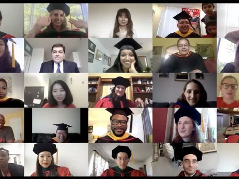 grid of graduates wearing regalia on a computer screen.