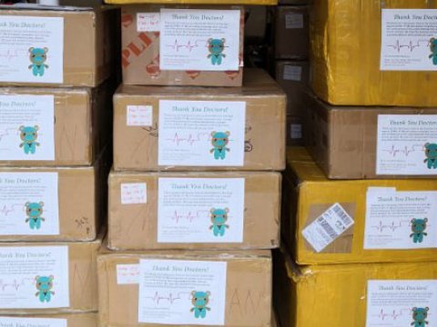 Stacks of boxes with labels that have a bear wearing scrubs.