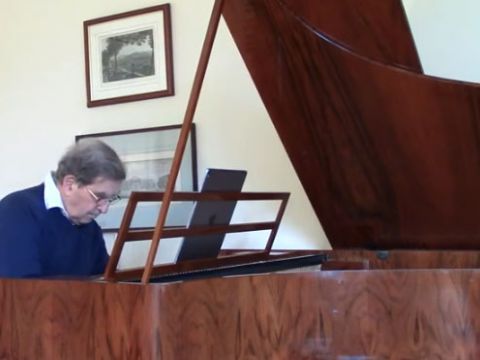 Video frame of a man playing the piano