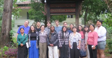 Students in Cambodia standing in front of at a conservation facility.
