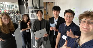 Students smile for a group selfie. 