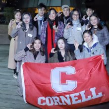 Group of students holding Cornell flag