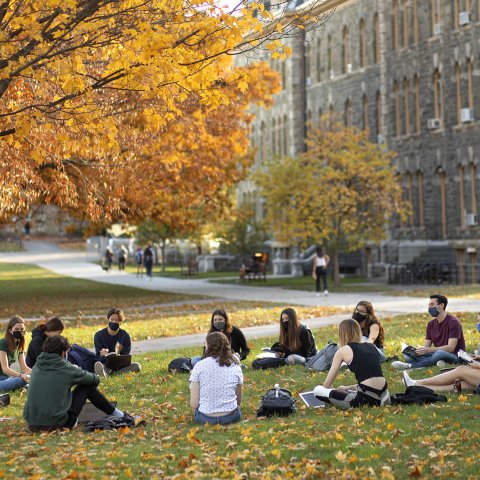 Students sitting in a circle on the Arts Quad.