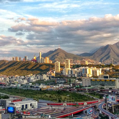 View of Monterrey with the city in the foreground and mountains in the background.