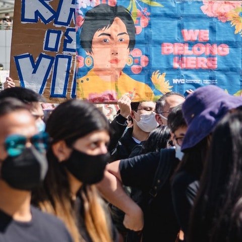 Crowd with masks protesting Asian hate.