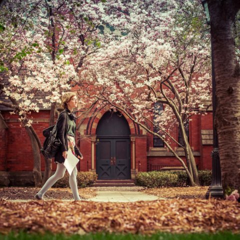 Woman walking on Cornell campus in spring 